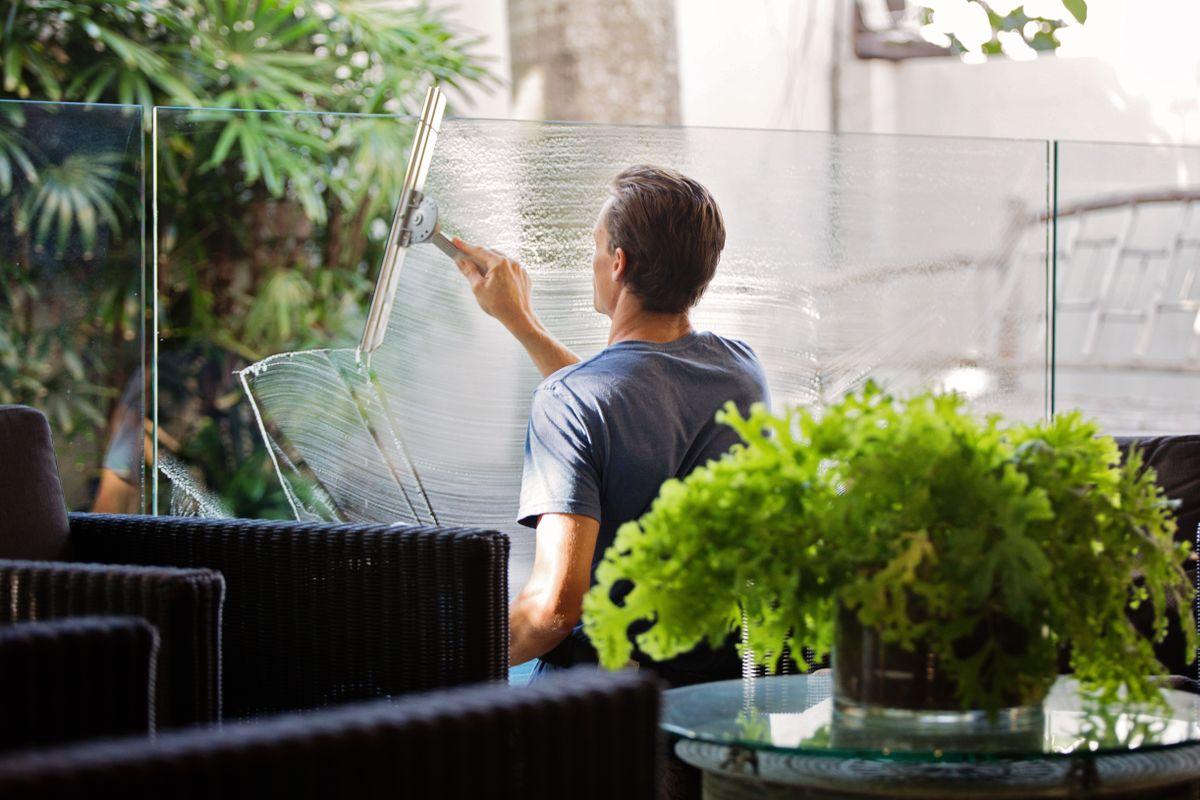 Window cleaner working on a large glass window